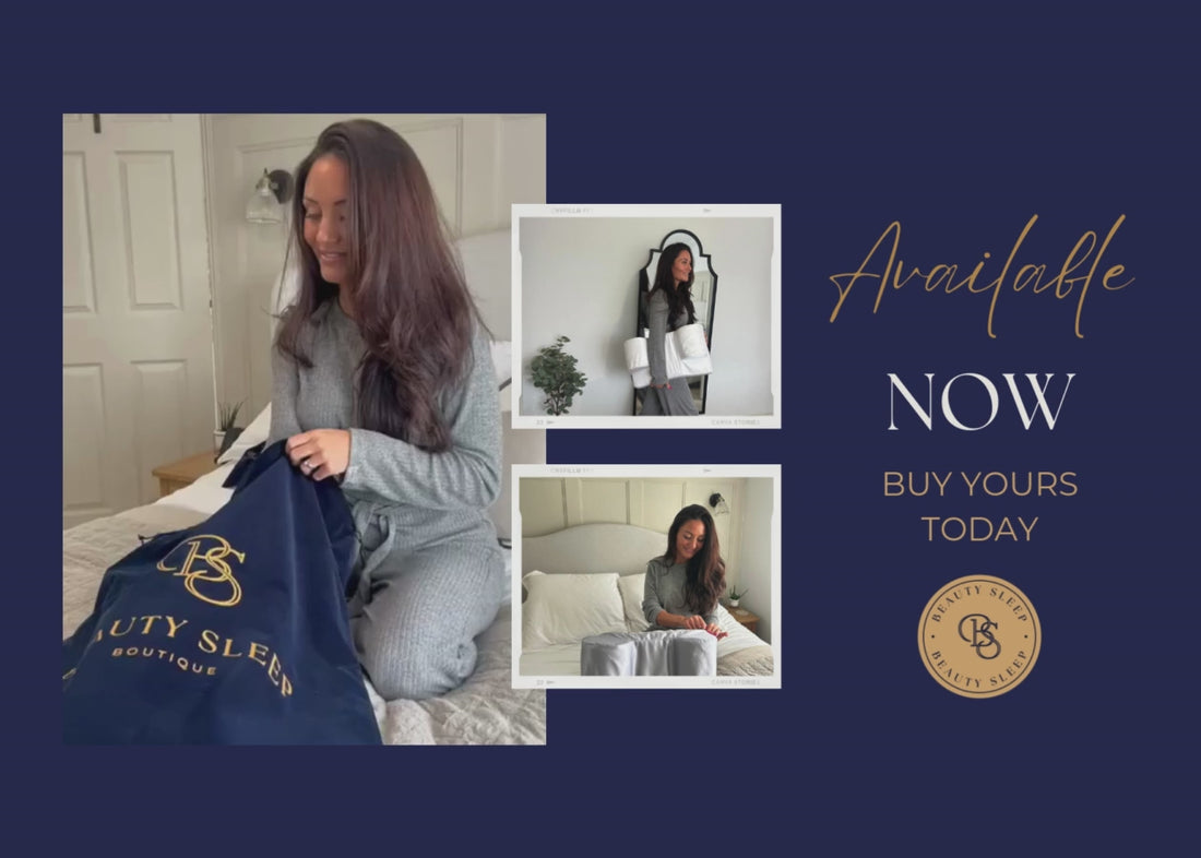 Woman sitting on bed with Beauty Sleep Back Sleeper™ pillow in grey loungewear.